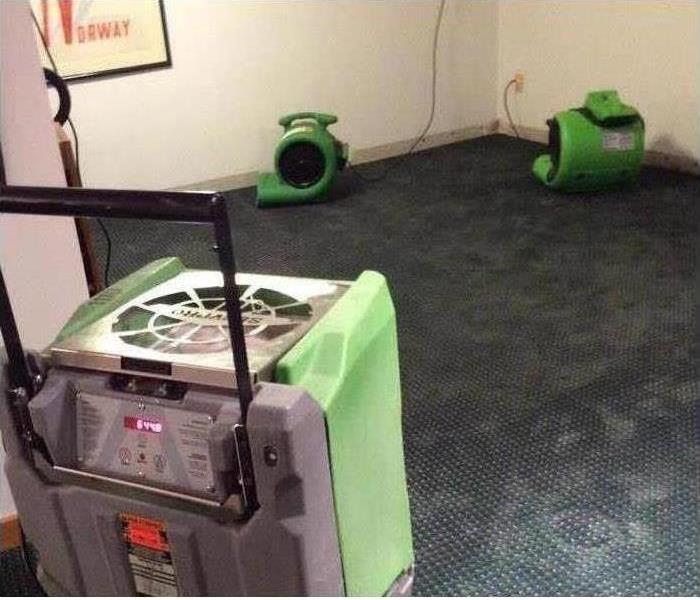 picture of a basement with SERVPRO equipment set up