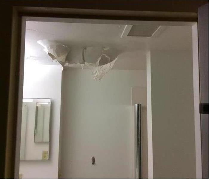 Picture of a bathroom ceiling falling in from water damage 
